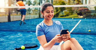 Buy stock photo Padel, typing and woman on court with phone, match schedule and social media update on rest. Tennis, fitness and athlete on turf with tech, wellness chat and virtual tutorial on training break.