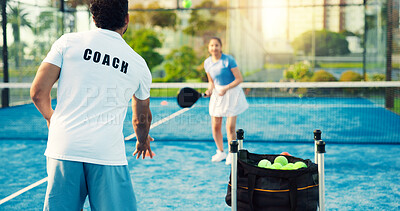 Buy stock photo Coach, woman and throw ball for padel training for coordination, power and exercise at sports club. People, mentor and athlete with racket, guide or fitness with back at tennis court for practice