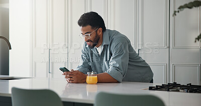 Buy stock photo Phone, juice and man in kitchen in home with networking, communication or social media on mobile app. Smile, technology and male person with cellphone for contact, texting or chatting in apartment.