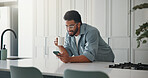 Phone, coffee and man in kitchen in home with networking, communication or social media on mobile app. Tea, technology and male person with cellphone for contact, texting or chatting in apartment.