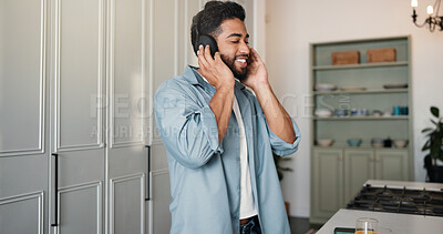 Buy stock photo Music, happy and man in house with headphones, podcast or listening on audio app. Enjoyment, sound track and Indian person in kitchen with technology, media or radio streaming on virtual subscription