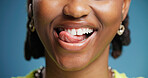 Dental, lick and teeth with black woman in studio for hygiene results or oral care satisfaction. Dentistry, mouth and tongue with happy African person on blue background for cleaning or whitening