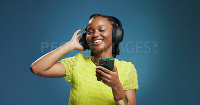 Buy stock photo Headphones, dance and black woman with phone on studio background for music, listen and playlist. Space, audio tech and African female person with smile for album, radio or song for rhythm and groove