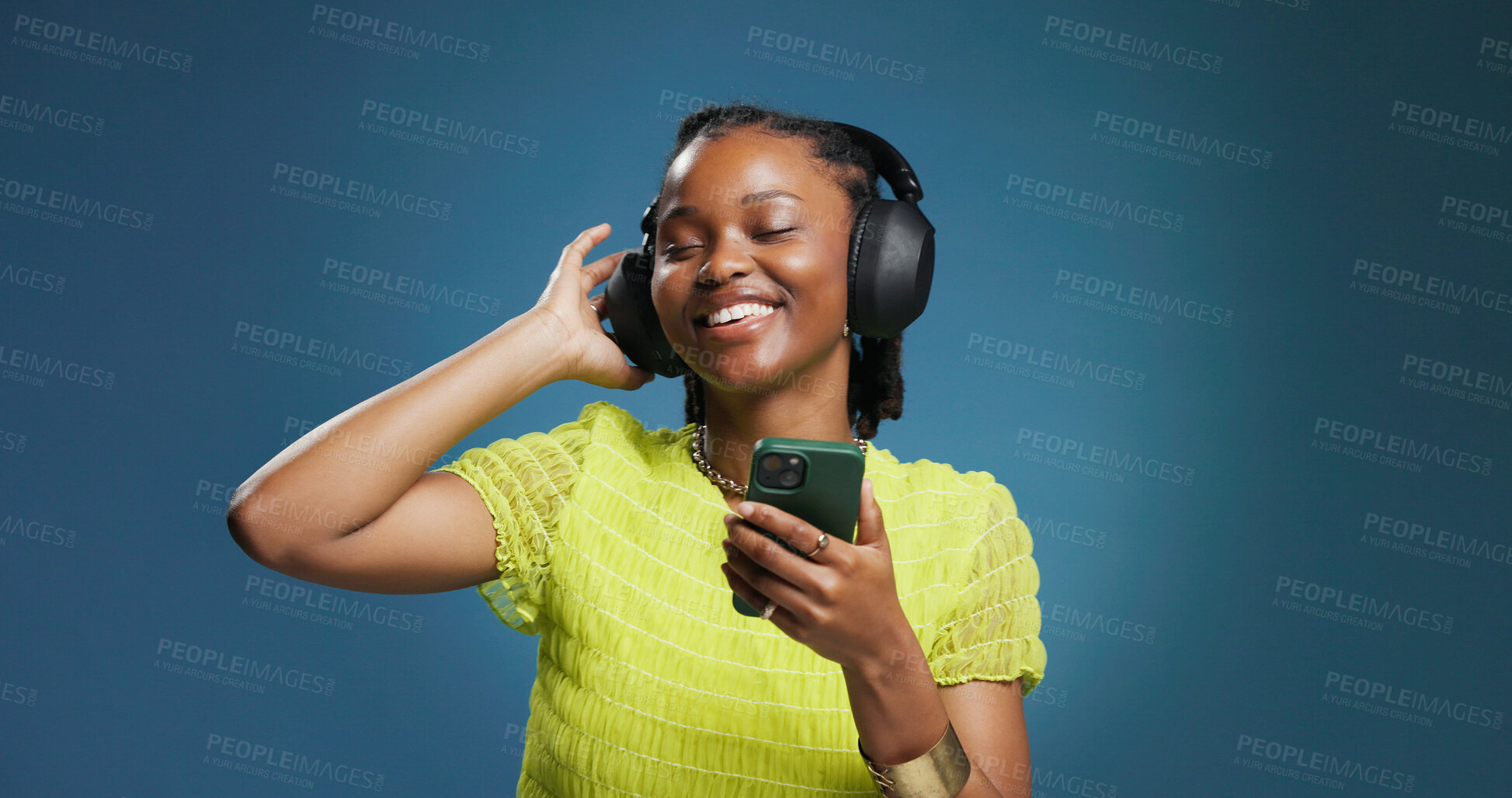 Buy stock photo Headphones, dance and black woman with phone on studio background for music, listen and playlist. Space, audio tech and African female person with smile for album, radio or song for rhythm and groove