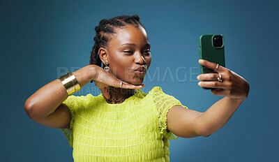 Buy stock photo Post, selfie and social media with black woman in studio for profile picture or status update. App, content creation and photograph with African influencer on blue background for streaming platform