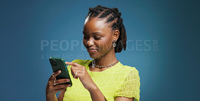 Buy stock photo Typing, smartphone and black woman in studio, internet and communication on blue background. Mockup space, mobile user and African person with cellphone, network and message to contact, app and email