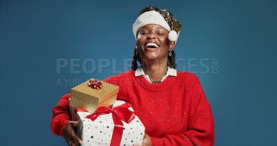Buy stock photo Boxes, Christmas and laughing with black woman in studio for celebration or surprise gift. Festive, present and smile with excited African person isolated on blue background for holiday tradition