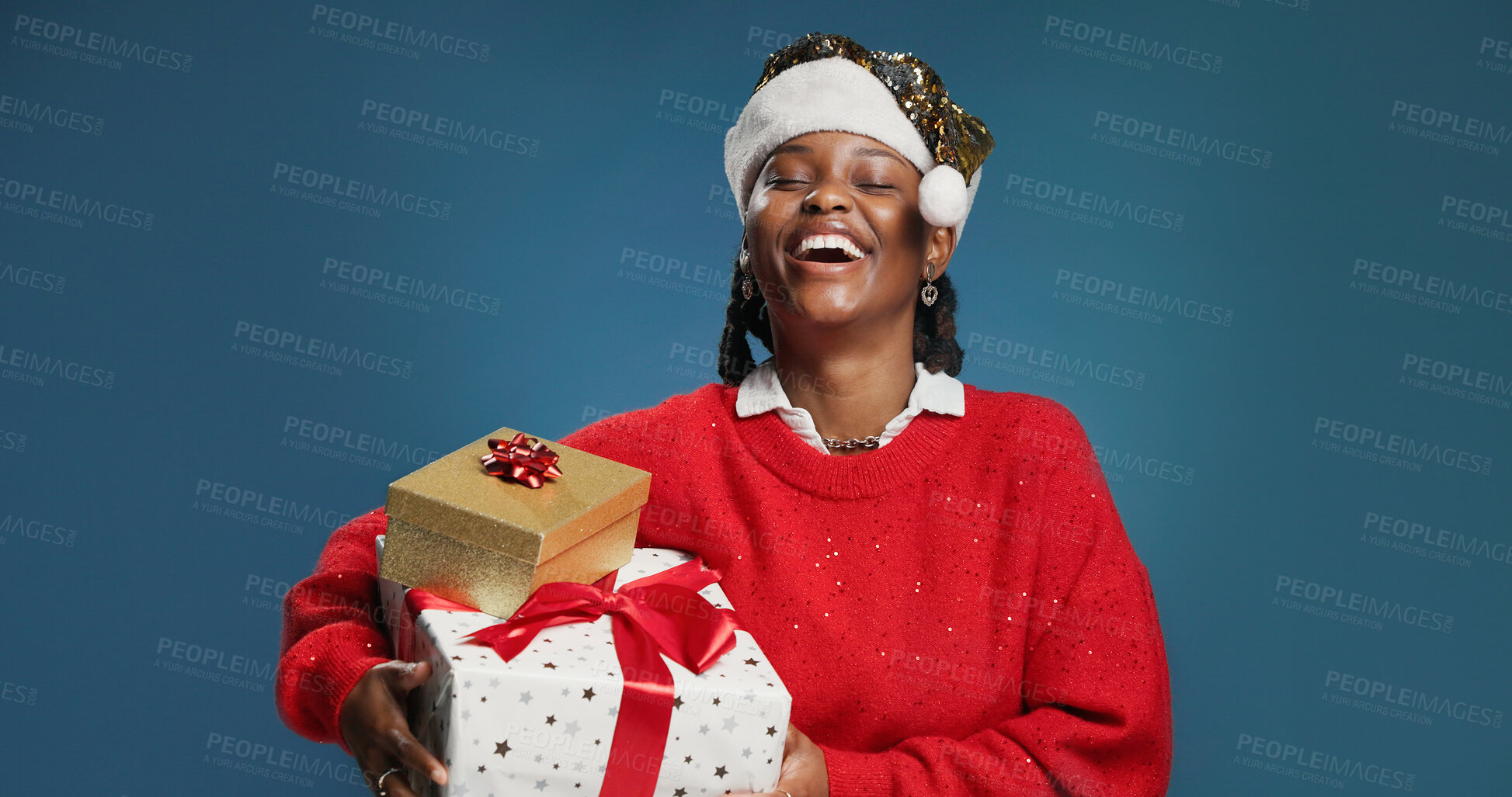 Buy stock photo Boxes, Christmas and laughing with black woman in studio for celebration or surprise gift. Festive, present and smile with excited African person isolated on blue background for holiday tradition