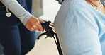 Support, nurse and hands in clinic with wheelchair, assistance or trust in disability care. Healthcare, rehabilitation or caregiver in hospital with mobility aid, help and empathy for retired patient