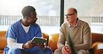 Tablet, checkup and nurse with mature man on sofa in home for diagnosis, discussion or treatment plan. Digital technology, consultation and medical caregiver with male patient in house for research.