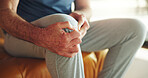 Hands, elderly man and knee pain in home with arthritis, muscle tension and fibromyalgia risk. Retirement, senior person and leg massage on sofa for inflammation, torn ligament and cartilage sprain