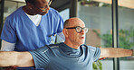 Help, physiotherapist and stretching with old man in office for support, chiropractor and rehabilitation. Consulting, physical therapy and recovery with senior patient in clinic for healthcare