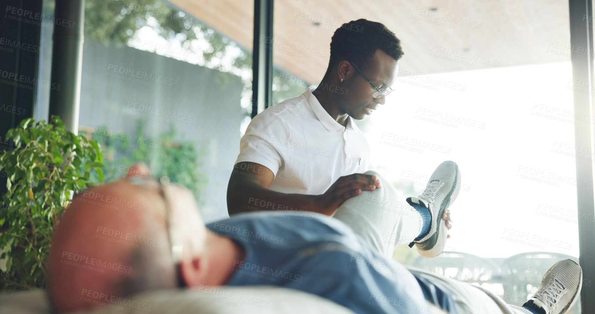 Buy stock photo Leg, support and stretching with old man and physiotherapist for help, chiropractor and rehabilitation. Consulting, physical therapy and recovery with senior patient in clinic for healthcare
