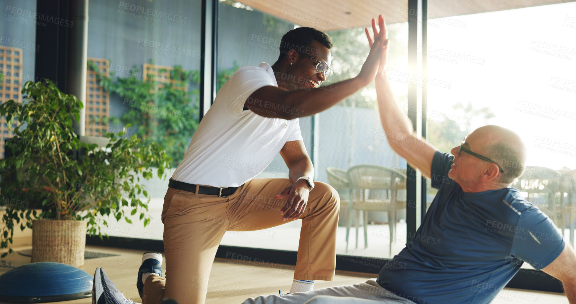 Buy stock photo Fitness, physiotherapy and high five with people in clinic for health, recovery or wellness. Exercise, rehabilitation or success with mature patient and therapist in office for medical support