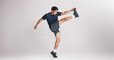 Buy stock photo Fitness, kick and stretching with man on studio space for start of training or workout routine. Exercise, legs and warm up with athlete on white background mockup for challenge or performance