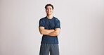 Portrait, athlete and man with arms crossed in studio for fitness, exercise pride and healthy body. Mockup space, bodybuilder and confidence for training, sportswear and happiness on white background