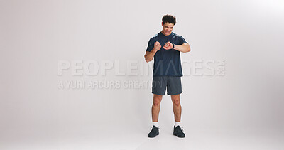 Buy stock photo Fist pump, smart watch and man in studio for fitness, mockup space or workout stats with goals. Celebration, sports and male athlete with tech for tracking training performance on white background.