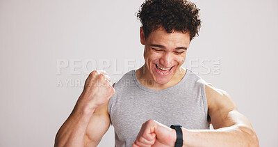 Buy stock photo Fist pump, smart watch and man in studio for sports, mockup space or workout stats with goals. Celebration, fitness and male athlete with tech for tracking training performance by white background.
