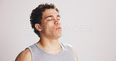Buy stock photo Break, breathing and fitness with man on studio space for recovery from training or workout. Exercise, fatigue and inhale with tired athlete on white background mockup for challenge or performance