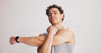 Buy stock photo Arm, exercise and portrait of man stretching on studio space for start of training or workout routine. Fitness, shoulder and warm up with person on gray background mockup for challenge or performance