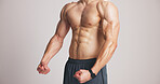Fitness, flex and man in studio with muscle, shirtless or strength check in workout results. Exercise, topless or bodybuilder on white background with squeeze, bicep or outcome in body transformation