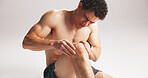 Man, massage or knee pain in studio from workout challenge, difficult exercise or training accident. Athlete, person or hurt leg with joint inflammation, sports injury or problem on white background.