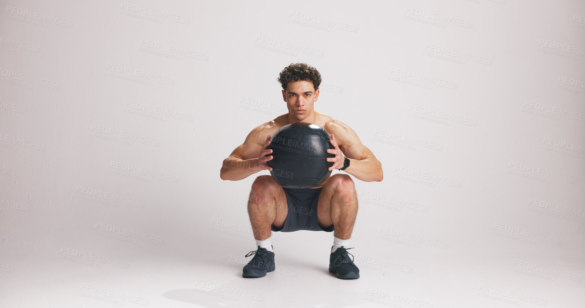 Buy stock photo Fitness, medicine ball and portrait of man on studio space for weight training or workout. Exercise, heavy and squat with serious athlete on white background mockup for challenge or performance