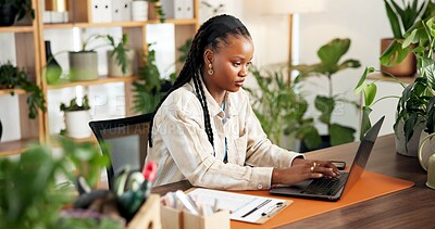 Buy stock photo Black woman, florist and typing on laptop for small business, inventory or online order for ecology. Plant shop, computer and person in office for stock, sales or review info in sustainable startup