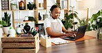 Black woman, happy florist and typing on laptop for small business, inventory or online order. Plant shop, computer and person in office for stock, sales info or floral arrangement in startup nursery