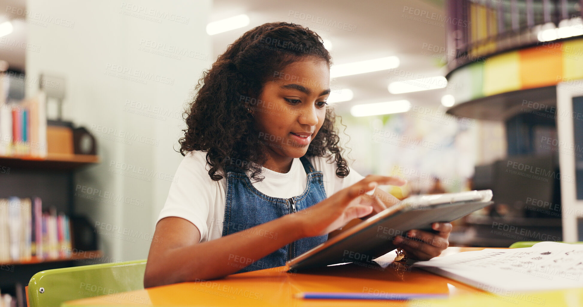 Buy stock photo Tablet, education and child in library for research online with studying for test, assignment or exam. Digital technology, learning and girl kid student reading information on app for knowledge.