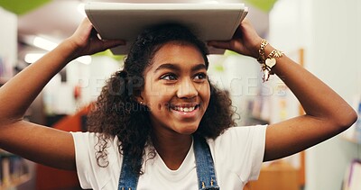 Buy stock photo Happy girl, student and education with book in library for study, learning or academic journey. Child, kid or learner with smile, story or novel for reading, knowledge or wisdom for youth development
