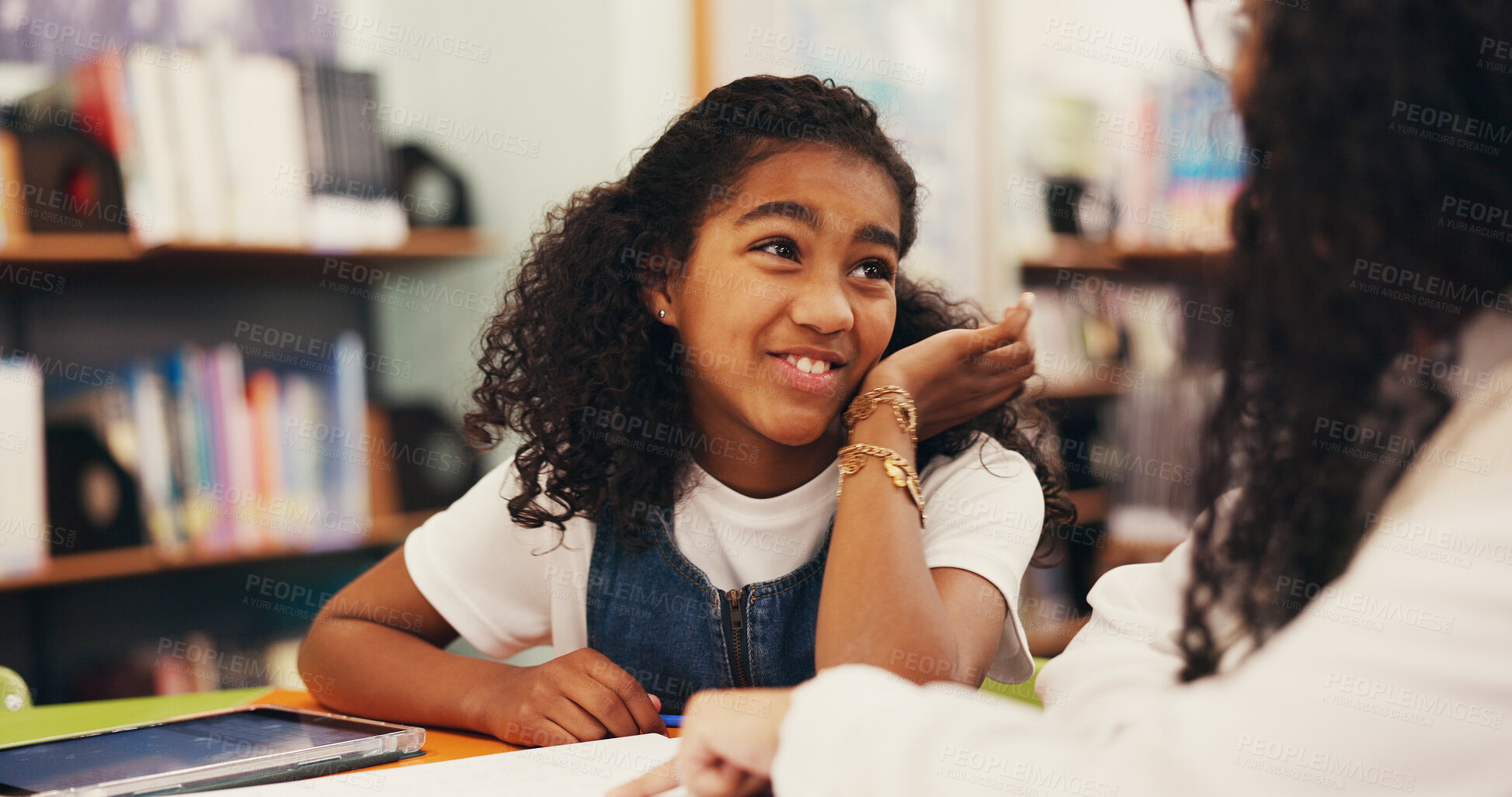 Buy stock photo Happy, kid and teacher with lesson in library for tutoring, learning support and test guidance. Study, tutor and student with conversation at school for exam preparation, homework assistance and help