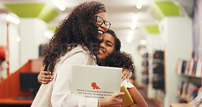 Buy stock photo Happy, teacher and kid with hug in library for reading support, literacy milestone and pride. Books, girl child and tutor with embrace at school for test preparation and gratitude for exam knowledge
