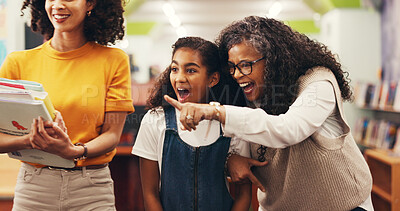 Buy stock photo Happy, grandma and mother in library with child, generations bonding, book choice and surprise. Mature woman pointing, mom and excited daughter in bookshop for literature, storytelling and knowledge.