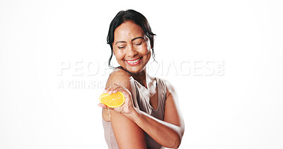 Buy stock photo Squeeze, beauty and woman with orange in studio for natural, organic or skincare cosmetics. Happy, vitamin c and mature female person with citrus fruit for antiaging dermatology by white background.