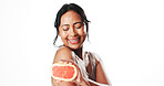 Squeeze, skincare and woman with grapefruit in studio for natural, organic or facial cosmetics. Happy, vitamin c and mature female person with citrus fruit for dermatology by white background.