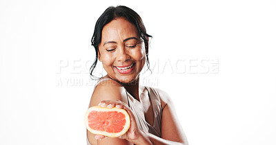 Buy stock photo Squeeze, skincare and woman with grapefruit in studio for natural, organic or facial cosmetics. Happy, vitamin c and mature female person with citrus fruit for dermatology by white background.