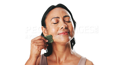 Buy stock photo Beauty, skincare or woman with gua sha in studio for self care routine, lymphatic drainage or depuff. Mockup space, mature person and jade stone on white background for blood circulation and benefits