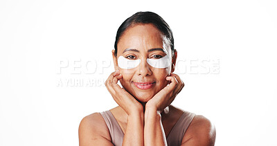 Buy stock photo Eye mask, white background and portrait of mature woman for dark circles, circulation and skincare. Mockup space, dermatology and person with beauty pads for wellness, hydration and health in studio