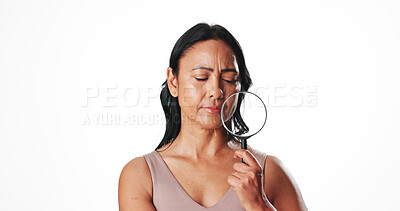 Buy stock photo Magnifying glass, skincare and mature woman in studio for beauty inspection, self care results and lens tool. Dermatology investigation, anti aging focus and glow with person on white background