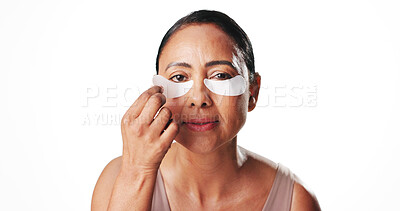 Buy stock photo Eye mask, skincare and portrait of mature woman for dark circles, circulation and dermatology. Mockup space, studio and person with beauty pads for wellness, hydration and health on white background