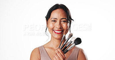 Buy stock photo Woman, makeup brush and studio portrait with smile, beauty and mock up space on white background. Mature person, cosmetics and happy with tools, foundation and confidence with makeover in Colombia
