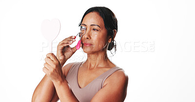 Buy stock photo Lashes, curler and mirror with woman in studio for volume, beauty and makeup tool. Eyelash extensions, mascara prep and self care with mature person on white background for cosmetics and routine