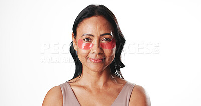 Buy stock photo Eye mask, portrait and mature woman in studio for dark circles, circulation and skincare. Mockup space, dermatology and person with beauty pads for wellness, hydration and health on white background