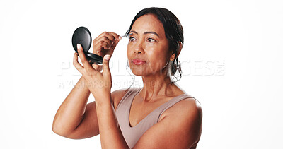 Buy stock photo Woman, tweezers and mirror in studio for eyebrows, shape or grooming with mockup space on white background. Mature person, cosmetics and tools for beauty, routine and check face with hair removal