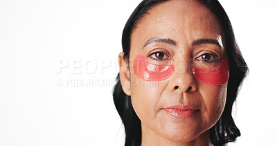 Buy stock photo Eye mask, space and portrait of woman in studio for dark circles, circulation or skincare. Mockup, dermatology and mature person with beauty pads for wellness, hydration or health on white background