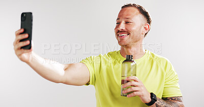Buy stock photo Selfie, water and fitness with man in studio for social media gym membership promotion and memory. Profile picture, personal trainer post and photography with person and bottle on white background