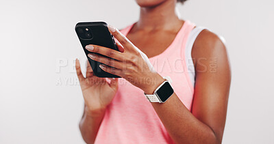 Buy stock photo Hands, phone and texting in studio with fitness, notification and tutorial video on white background. Person, smartphone and scroll on mobile app for training, stats or tips for exercise on web
