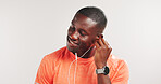Black man, earphones and happy for fitness in studio, streaming and mockup space on white background. African person, smile and listen to music with audio subscription, exercise or training routine
