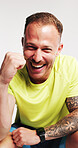 Happy man, fitness and fist pump in studio portrait, excited and goals with pride on white background. Person, athlete and smile for success, achievement and confident for training routine in Germany